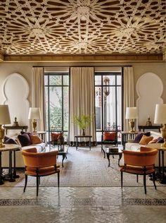 a living room filled with lots of furniture and decor on top of a tiled floor