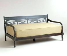 a wooden bench with a beige cushion on it