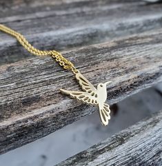 "This adorable necklace has a hummingbird charm. The metal is a gold color and you may choose the length of your necklace. This would make a great gift for a birthday, an anniversary, Christmas or any other occasion. Size: about 1\" wide x 1 1/8\" tall Metal: alloy, nickel free All jewelry items come in a gift box." Gold Necklace With Bird Design For Gift, Gold Necklace With Bird Design As Gift, Gold Hummingbird, Hummingbird Necklace, Petoskey Stone, Gift For Anniversary, Memory Locket, Mother Wedding Dress, Little Flowers