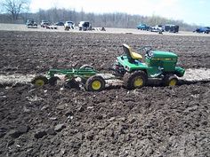 a tractor is plowing the field with it's front end