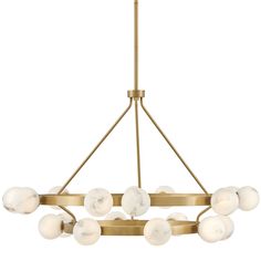 a brass chandelier with white glass balls hanging from the bottom, on a white background