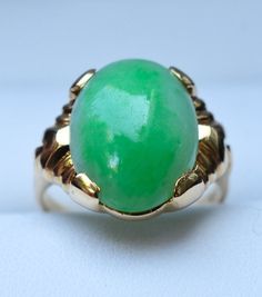 "Category Type: Rare Fine Jewelry Metal Purity:14K Yellow Gold Ring Size US: 4 3/4 Center Stone: Highest Quality Grade \"AAA\" Untreated Jadeite Jade Stone Creation: Grade \"A\" Finest Untreated Imperial Quality Jadeite Jade Additional Stones: Natural Diamond Accent Jadeite Stone Size: 6 Carat - 15mm x 12mm Ring Total Weight: 4.7 grams Condition: Preowned / Like New" Green Opal Oval Ring In 14k Gold, Classic Green Oval Opal Ring, Formal Green Jewelry With High Luster, Heirloom Green Emerald Oval Cabochon Ring, Heirloom Green Oval Cabochon Emerald Ring, Formal Green High Luster Jewelry, Heirloom Green Oval Opal Ring, Green Oval Opal Ring For Formal Occasions, Classic Green Opal Cabochon Ring