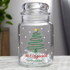 a glass jar with a christmas tree on it