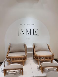 two wooden beds sitting next to each other in front of a wall with the name ame on it