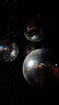 three shiny disco balls hanging from the ceiling