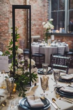 the table is set with silverware, plates and place settings for an elegant dinner