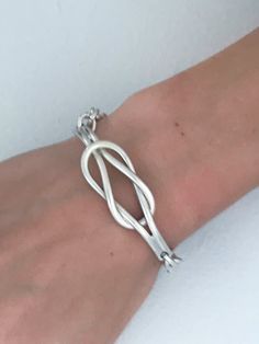 "Retro Tubular Double Knot Chain Link Toggle Bracelet. Sturdy solid silver 28.70 gram cuff that is always in fashion. Lightly Cleaned Ready to wear. Makers Mark: 925 stamped Weight: 28.70 grams Size: Total Inside circumference including closed is 6 3/8\" wo wrists up to that size. Knot is 2 1/4\" Long x 5/8\" wide. Condition: Good vintage defect free ready to wear condition with standards signs of use for a vintage item. View photos of actual item. Please review the photos for visual detail and Silver Bracelet With A Modern Twist, Modern Twist Silver Bracelet, Silver Bracelet With Modern Twist For Anniversary, Modern Twist Sterling Silver Bracelets, Modern Silver Sterling Silver Bracelet, Modern Sterling Silver Bracelets, Modern Sterling Silver Bracelet As Gift, Sterling Silver Bracelet With Clasp For Wedding, Adjustable Sterling Silver Bracelet With Toggle Clasp