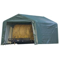 a covered trailer with hay in the back