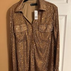 This Listing Is For A Nwt Long Sleeve Sequin Button Down Shirt By Ny&Co. It’s In A Women’s Xl. The Shirt Shown Is The Same One Being Sold/Shipped. It Has Been Kept In A Clean, Smoke Free Environment. Please Make Sure To View And Zoom In On All Photos To Determine The Condition Of The Shirt. Sorry For The Super Speed In The Videos. I Tried To Capture The Entire Item And Then Had To Speed It Up To Fit The Allotted Time. All Orders Ships Out Within The Stated Handling Time. Overview Long Sleeve Seq Gold Button-up Top For Night Out, Long Sleeve Sequin Shirt For Fall, Gold Party Top With Button Closure, Gold Party Tops With Button Closure, Gold Tops With Button Closure For Party, Gold Shirt With Buttons For Fall, Gold Party Tops With Buttons, Gold Button-up Blouse For Night Out, Gold Long Sleeve Tops With Buttons