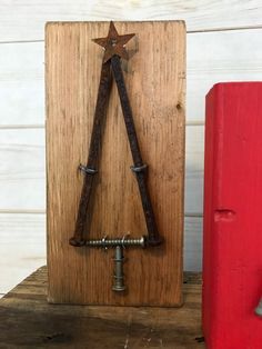 a christmas tree made out of wood and metal pipes on top of a wooden shelf