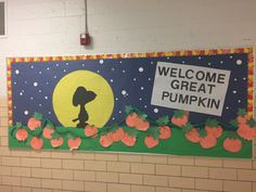 a bulletin board with pumpkins and a welcome great pumpkin sign on the front wall