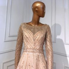 a mannequin wearing a dress with sequins and beads on it's chest