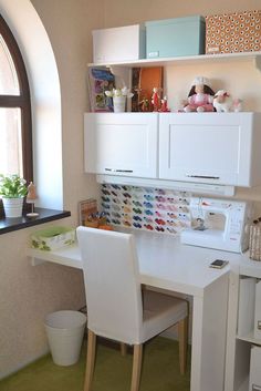 a white desk and chair in a small room