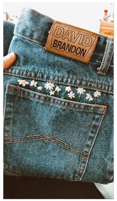 the back pocket of someone's jean pants with flowers on them and a name tag that says david brandon