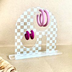 an elephant shaped object with pink and purple rings on it