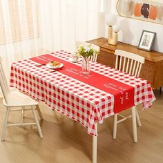 a red and white checkered table cloth on a dining room table