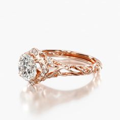 a rose gold engagement ring set with an oval diamond center and twisted band, on a white background