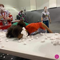 children are playing with marshmallows on a table