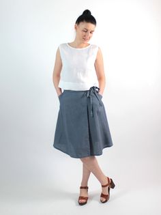 "Handmade natural washed linen wrap skirt. Made with love for You. *100% local medium weight washed linen *Each item is individually cut and sewn by order *The model is wearing size S, skirt color - Grey *Note that colors may look different on your display depending on their settings and technical characteristics. Please let us know if you need different measurements or colors. CARE *Machine wash up to 40 / 104F gentle cycle *Iron inside out at medium high *Do not bleach *Do not tumble dry MAKIN Casual Linen Asymmetrical Skirt, Casual Asymmetrical Linen Skirt, Linen Wrap Skirt, Linen Kimono, Mid Calf Skirt, Wrap Shorts, Linen Style, Skirt With Pockets, Gray Linen