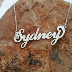 🌹 Order ANY name for my Sterling Silver Sydney style name necklace. (One name with one capital letter for this listing) 🌹 Choose any name or word, your chain length and birthstone as well. 🌹 Custom made by me in solid sterling silver (both the name and the chain). Birthstones in the dot of the i, or first capital letter. 🌹 1.2 mm upgraded nameplate thickness; your choice of any length box chain. 🌹 Select the chain length and stone...then be sure to tell me the name for your necklace in a no Custom Name White Gold Nameplate Necklace, Sterling Silver Initials Name Necklace For Birthday, White Gold Custom Name Initial Pendant Necklace, Custom Name White Gold Initial Pendant Necklace, Sterling Silver Initials Necklace For Birthday, Custom Name Initial Pendant Necklace In White Gold, Customized Sterling Silver Name Necklace For Birthday, Customized Sterling Silver Name Necklace For Anniversary, Personalized Silver Necklace With Names