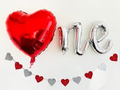 the word love spelled out with red and silver balloons