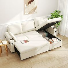 a white sectional sofa with storage underneath it