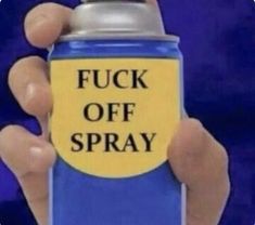 a hand holding a spray can with the words f k off spray on it's side