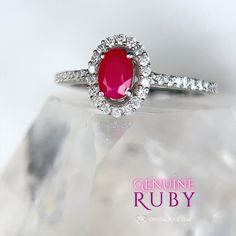 Genuine Ruby Oval Faceted Halo Sterling Silver Ring Add this beautiful pink Ruby halo ring and elevate your jewelry collection. This ring boasts an oval cut natural Ruby gemstone that exudes elegance and sophistication. The accented halo twinkles around the opaque Ruby, while the pave band will take your breath away with its sparkling accent stones. Whether you're treating yourself or looking for the perfect gift for a loved one, this Ruby ring is a beautiful choice for someone looking for a memorable design. Makes a stunning gift for a July birthday recipient as Ruby is the July birthstone. Ruby is considered a stone of love and vitality. Ruby is part of the Corundum crystal family and gets its beautiful pink tones from trace mineral elements of chromium. Sizes Available: 5, 7, 8, 9 DIMEN Dazzling Oval Ruby Promise Ring, Luxury Oval Ruby Ring With Halo Design, Dazzling Oval Ruby Ring With Halo Setting, Oval Ruby Halo Ring Fine Jewelry, Oval Ruby Ring With Diamond Halo, Oval Ruby Halo Ring With Center Stone, Elegant Oval Ruby Ring With Halo, Oval Ruby Ring With Halo Design, Elegant Oval Halo Ruby Ring