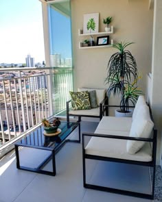 two chairs and a table on a balcony