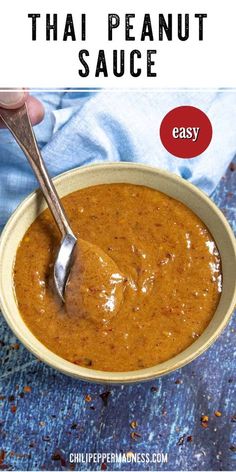 a hand holding a spoon in a bowl of thai peanut sauce with text overlay