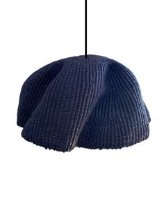 a blue hat hanging from a black cord