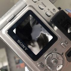 a person holding up a camera with a dog on the screen