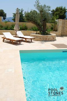 an empty swimming pool with lounge chairs around it