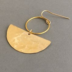 Hammered 14k gold fill half discs hang from circle hoops and earwires. Earrings from top of earwire measure 1.75 inches long and 1.25 inches wide. Also available in a sterling silver option with sterling silver earwires. Comes packaged in a small jewelry box. Gold Crescent Hoop Earrings With Ear Wire, Handmade Semi-circle Gold Jewelry, Gold Semi-circle Brass Jewelry, Gold Crescent Hoop Earrings In Brass, Gold Hammered Crescent Earrings, Gold Crescent Hammered Earrings, Gold Hammered Crescent Hoop Earrings, Gold Crescent Hoop Earrings With Hammered Detail, Gold Semi-circle Brass Earrings