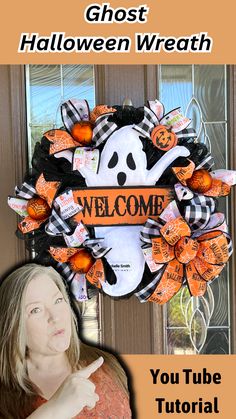 a woman standing in front of a halloween wreath with the words ghost welcome on it