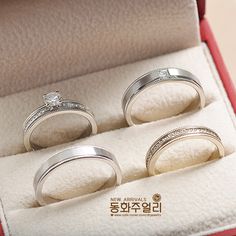 three wedding rings sitting in a red box