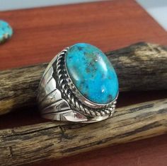 "Navajo Sterling Silver and Fox Turquoise Ring Very nice Royston Turquoise Stone in wonderful condition, and an excellent finish. There are no breaks or damage to the stone. The cab is set in a smooth bezel setting. Below the bezel is a twisted wire accent. The shank is solid base and a shield covering on both sides. Each of the shields has accent stamping Condition is very good - Cab Condition - Excellent - Color is predominantly blue with light blue highlights and brown matrix Cab - 1\" x 3/4\ Navajo Turquoise Ring, Western Style Untreated Turquoise Ring Gift, Untreated Western Turquoise Ring As Gift, Southwestern Polished Turquoise Ring, Untreated Western Style Turquoise Ring Gift, Southwestern Style Polished Turquoise Ring, Untreated Southwestern Oval Jewelry, Untreated Blue Western Jewelry, Western Style Turquoise Ring