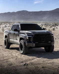 a gray truck is parked in the desert