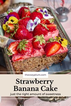 a piece of cake with strawberries and flowers on top is being cut by a knife