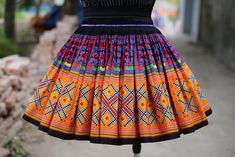 This stunning skirt is a harmonious blend of artistry, culture, and modern aesthetics, bringing a touch of elegance and vibrancy to your wardrobe. Made from high-quality, breathable fabric, this skirt offers both comfort and style. The skirt strap can be adjusted to different measurements. Length ~ 45cm. I can customize the length skirt, kindly note for me in the personalization box if you want to change it The machine print pattern on this Hmong skirt adorning the skirt is inspired by the tradi Bohemian Multicolor Skirt For Festivals, Bohemian Multicolor Skirt For Fiesta, Multicolor Bohemian Skirt For Fiesta, Traditional Multicolor Skirt For Summer, Bohemian Fitted Skirt With Multicolor Embroidery, Traditional Pattern Long Skirt For Festival, Traditional Mini Skirt For Festival, Traditional Flared Skirt For Festival, Traditional Multicolor Skirt For Festival