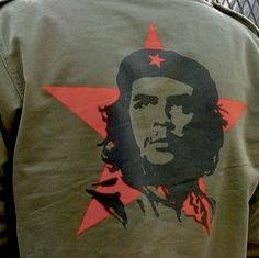 the back of a man's green jacket with a red star on it