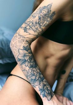 a woman's arm with flowers on it, and a tattoo on her left arm