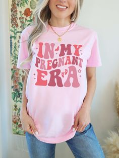 Pregnant Mom Shirt, Mother to Be Shirt, In My Pregnancy Era, New Mom Shirt, Pregnant Mom Gift, Comfort Colors®, In My Mom Era Shirt  F I T ∙ & ∙ S I Z I N G : -->These Unisex T-shirts have a modern-fit. Consult the size chart in the pics for an accurate fit. -->Women's sizes are narrower than the waist. -->Sleeves are rolled up in some product pictures. They do not come rolled up on delivery. T I M E ∙ T O ∙ D E L I V E R Y : -->Processing and production time is 1-2 business days. -->Delivery ti Pink Tops With Funny Text For Gender Reveal, Maternity Short Sleeve Top With Letter Print, Maternity Tops With Letter Print And Short Sleeves, Pink Cotton Maternity Top, Pink Tops With Funny Print For Gender Reveal, New Mom Shirts, Pregnant Mom Gifts, In My Mom Era, New Mom Shirt