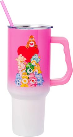 a pink and white cup with a teddy bear design on the side, holding a straw