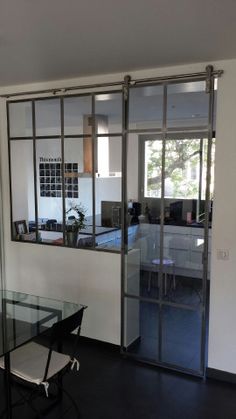 a glass table and chairs in a room