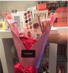 a pink vase filled with lots of different items