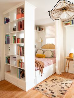 a bedroom with bookshelves and a bed in it