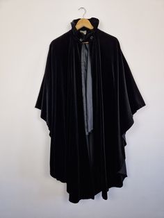 This item is from our Outlet section therefore it might be of a lower quality than our standard vintage selection. It might have some visible flaws or require some alterations or repairs. Please read description and check photos carefully. Vintage 80s Laura Ashley black velvet opera cape cloak. Arm holes, collar, half lined. Theatre costume Opera Victorian Edwardian Gothic Fabric: 73% cotton 27% modal  Brand: Laura Ashley / Made in Great Britain The stitching on one arm hole has gone. Two small Ashley Black, Costume Capes, Theatre Costumes, Laura Ashley, Cloak, Vintage Wear, Costume Accessories, Cape, Opera