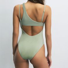 The Luna series, notable for its playful neckline details and comfortable fit, is an ideal option for those who prefer a simple and elegant style at the beach. This swimsuit, which can be comfortably worn both at the beach and by the pool, will provide comfort throughout the day. You can complete the look with denim pieces and carry your beach elegance to the city. Back neckline. Adjustable straps. Ribbed trim fabric. Gold-plated House of Silk gem at the center of the chest. 81% Polyamide 19% El Chic Backless Swimwear With Seamless Construction, Chic Green One-piece Swimsuit For The Beach, Seamless One-piece Swimwear, Chic Seamless Bodysuit For The Beach, Chic Green One-piece For The Beach, Chic Seamless Swimwear For Poolside, Beachy Sleeveless Seamless Swimwear, Backless Seamless Swimwear For Beach, Backless Seamless Swimwear For Summer