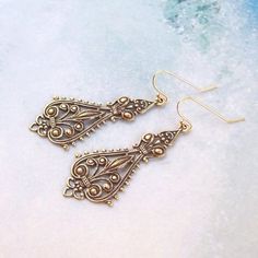 Beautiful, ox solid brass, filigree drops hang from 14K gold filled ear hooks/wires. Open back.Very simple, yet elegant, and they go any where, any time.Total earring length is approx. 2".-All components of my jewelry are made without lead and nickle.-All sterling silver is 925, nothing less. It is also tested on a regular basis for strength.-All rhodium/silver/gold/bronze/gunmetal plates are quality pieces.-Best of all, since I am particular about my components, I love to shop for supplies and Victorian Earrings, Brass Filigree, Filigree Earrings, Love To Shop, Ox, Earrings Gold, Fall Fashion, Solid Brass, My Jewellery